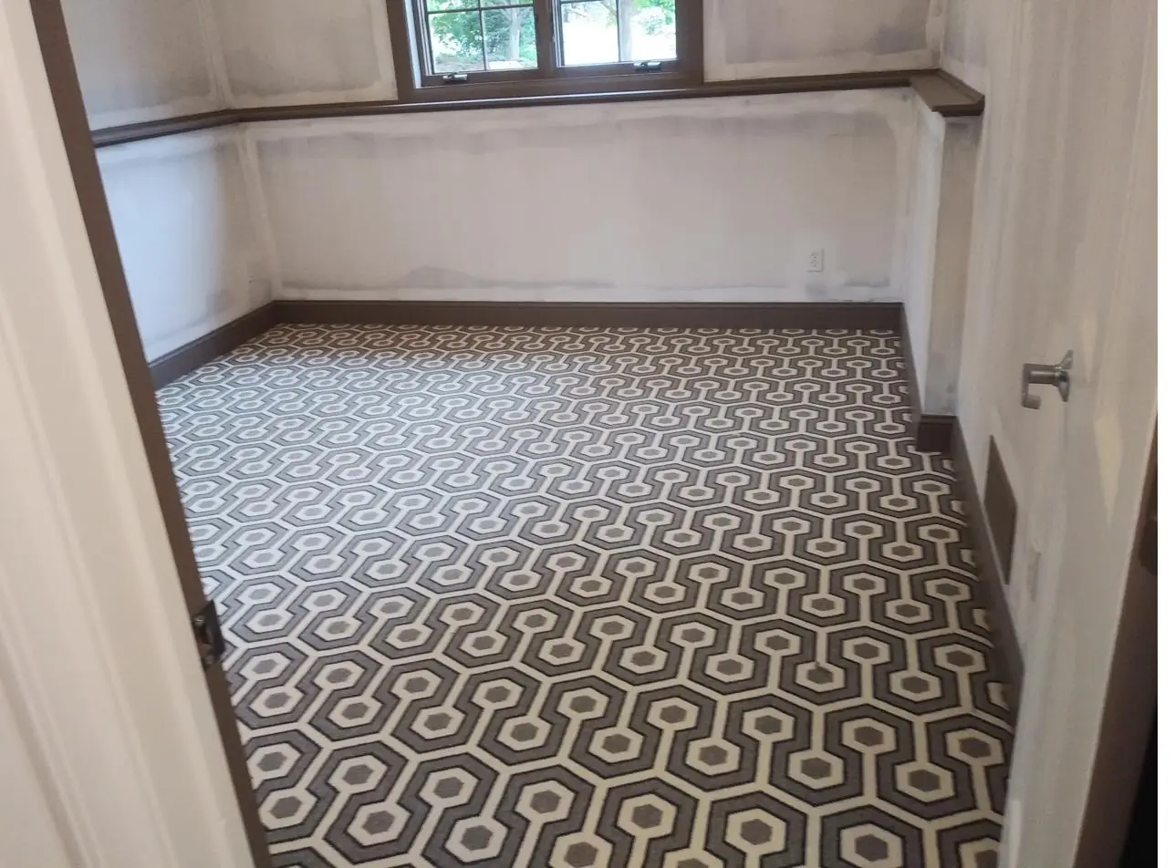 Geometric patterned carpet in a den — a QFI install