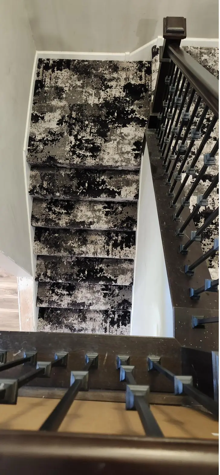 Black and white patterned runner with iron balusters — a QFI install