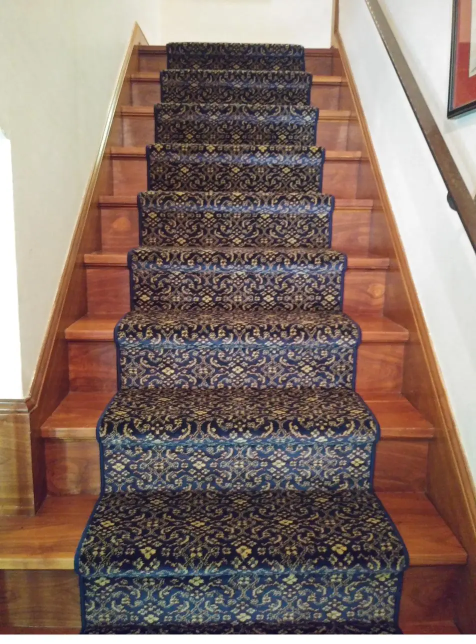 Ornate patterned runner — wood staircase, installed by QFI