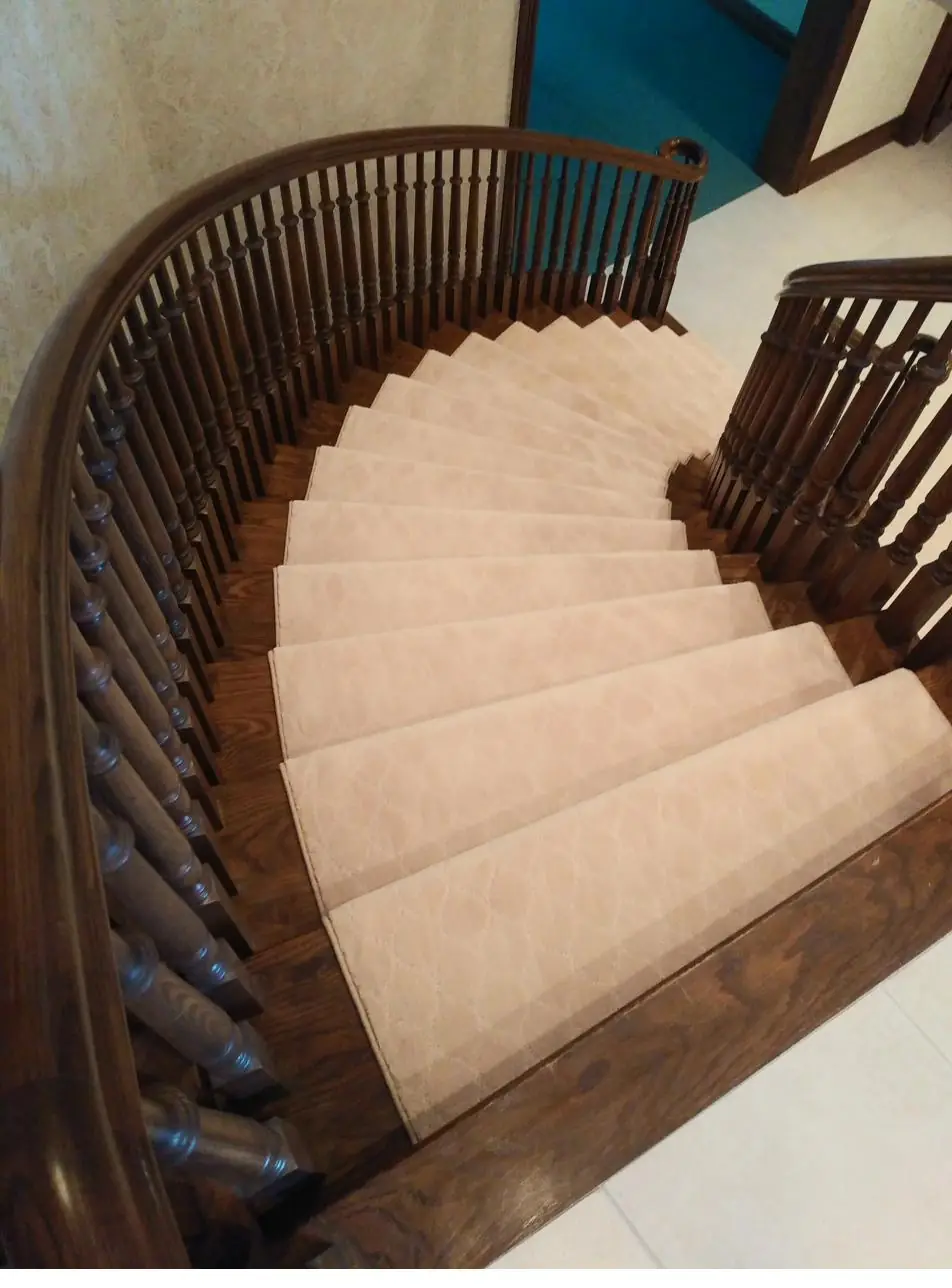 Soft cream carpet — curved staircase, installed by QFI
