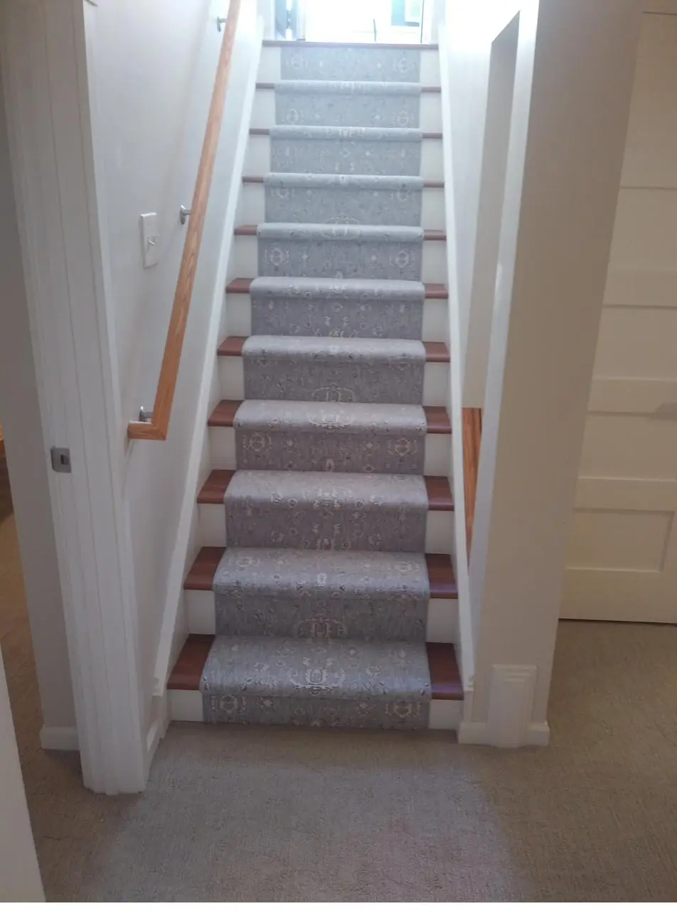 Greige carpet — straight staircase, installed by QFI