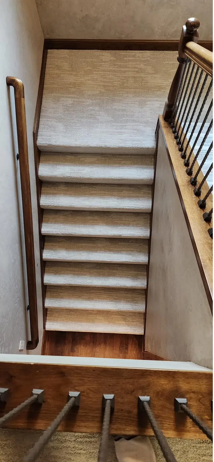 Warm beige carpet — white-spindle staircase, installed by QFI