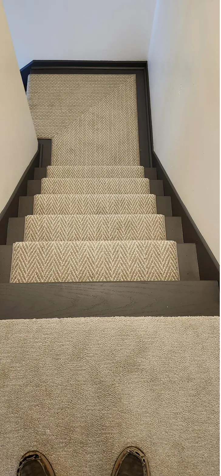 Neutral carpet — stairs from above, installed by QFI
