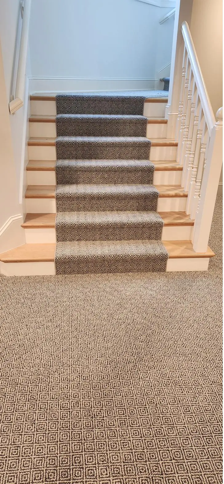 Herringbone-texture carpet — lower-level stairs, installed by QFI