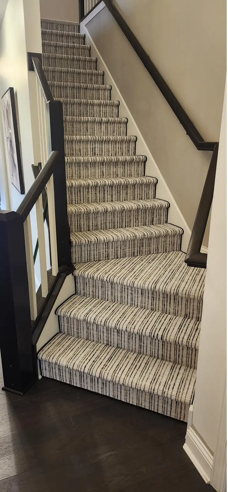 Gray striped runner — dark-rail staircase, installed by QFI
